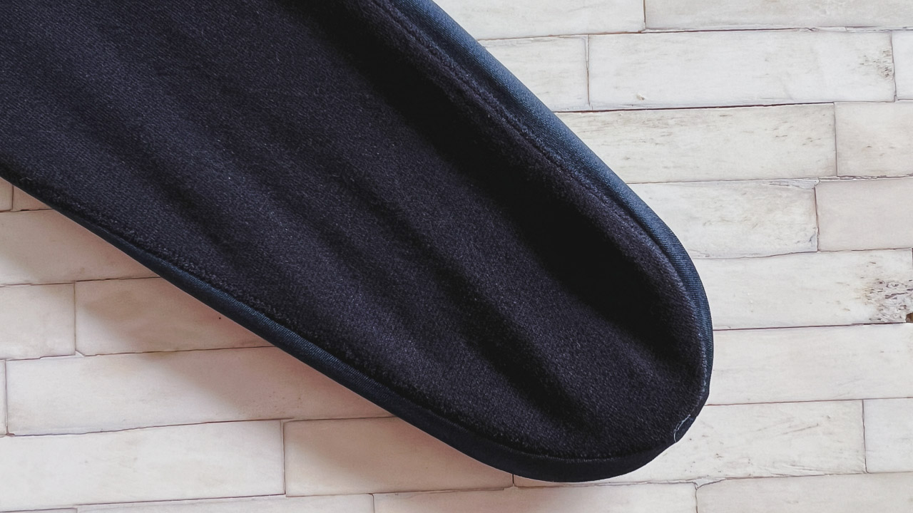bottom of black no show sock on white tile table