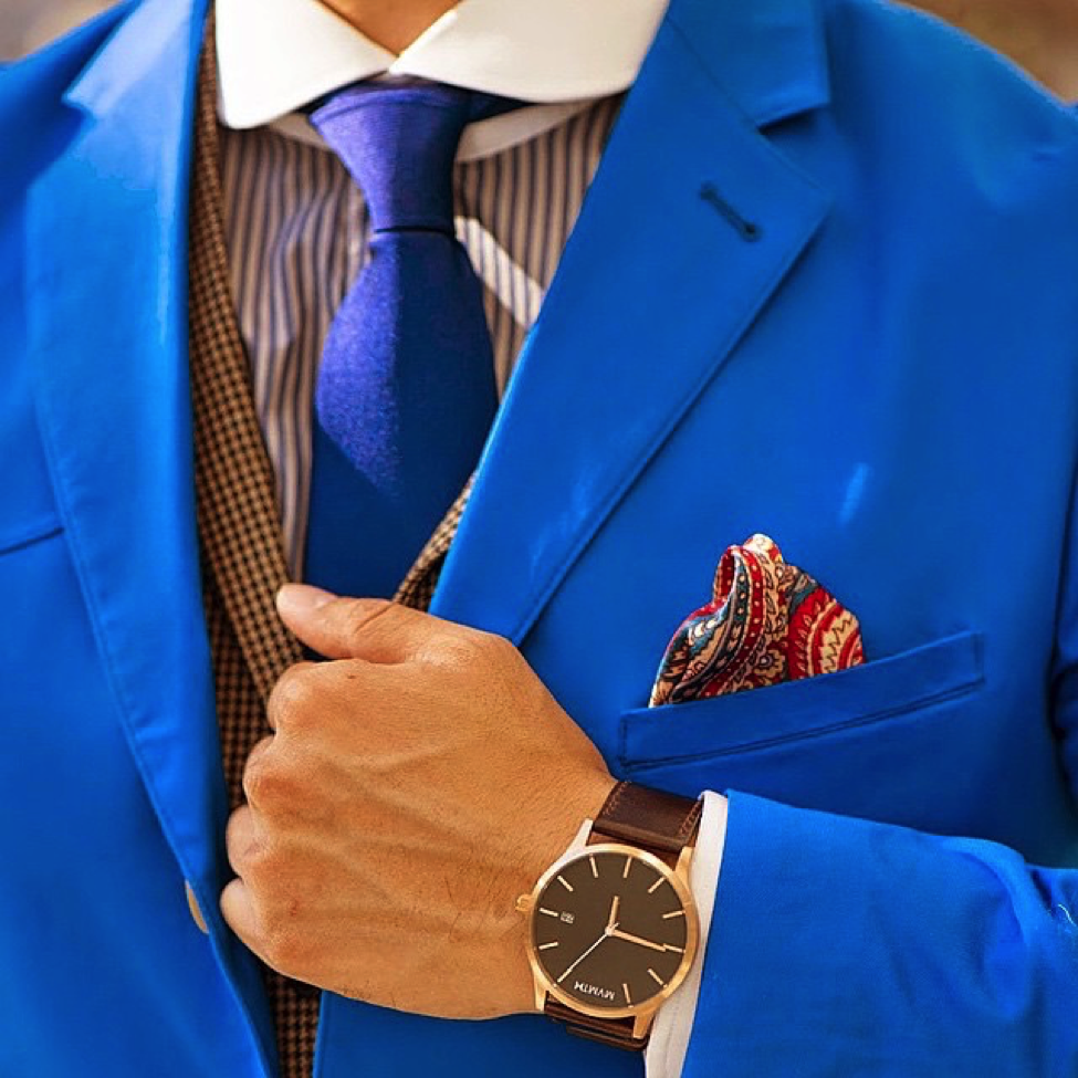The Dark Knot’s Waterbury Blue Solid Silk Tie over a striped shirt.