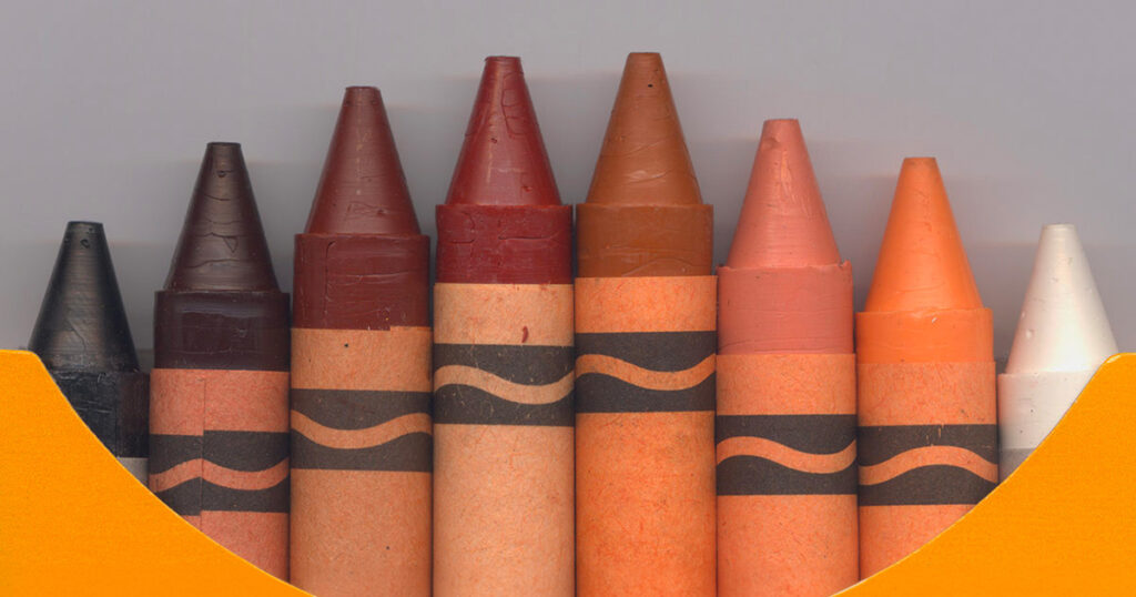 closeup of box of crayons with all skin tones