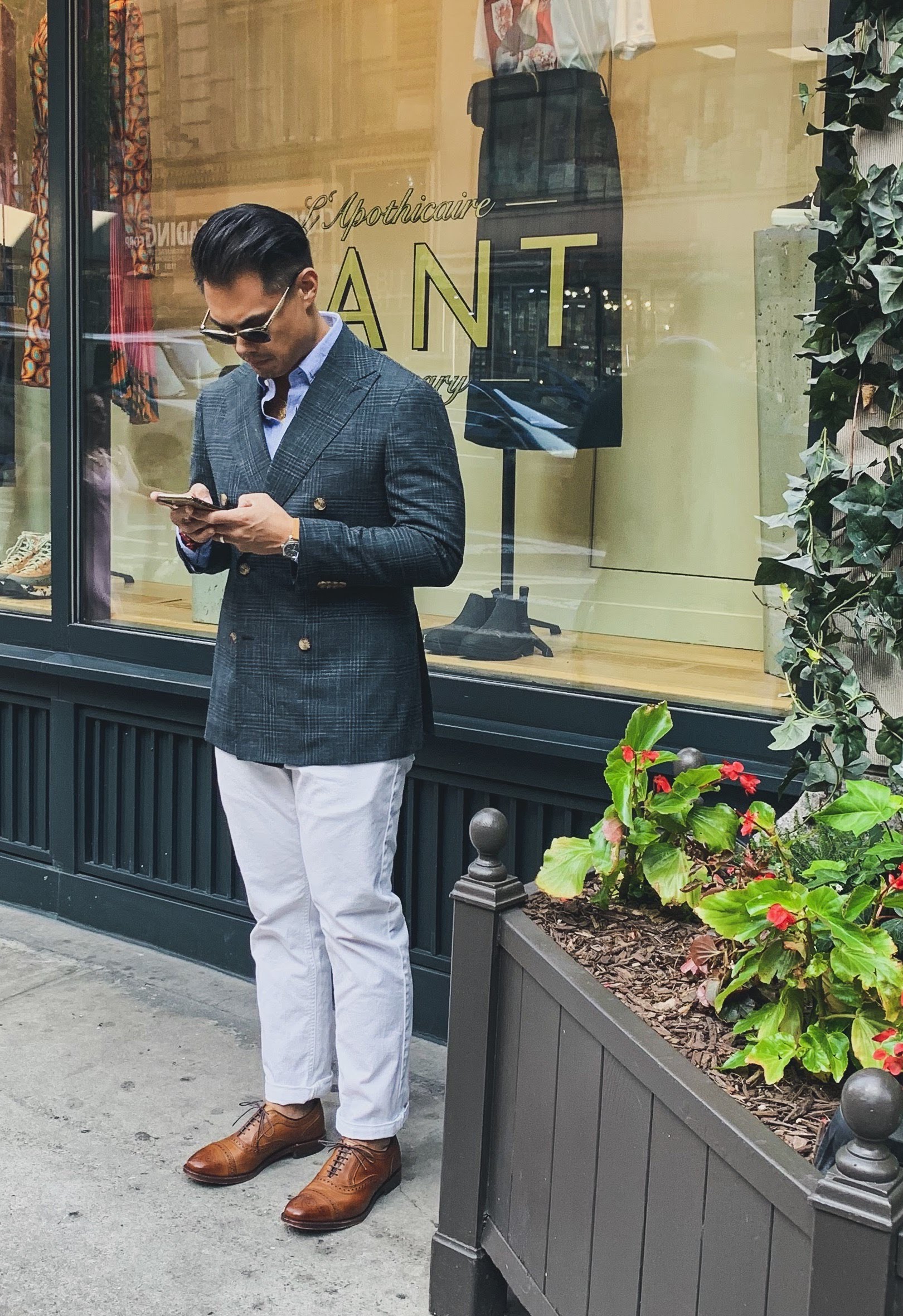 man wearing green plaid sportcoat with white denim and tan leather shoes