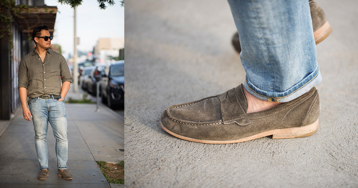 asian man wearing light blue denim olive shirt and grey loafers