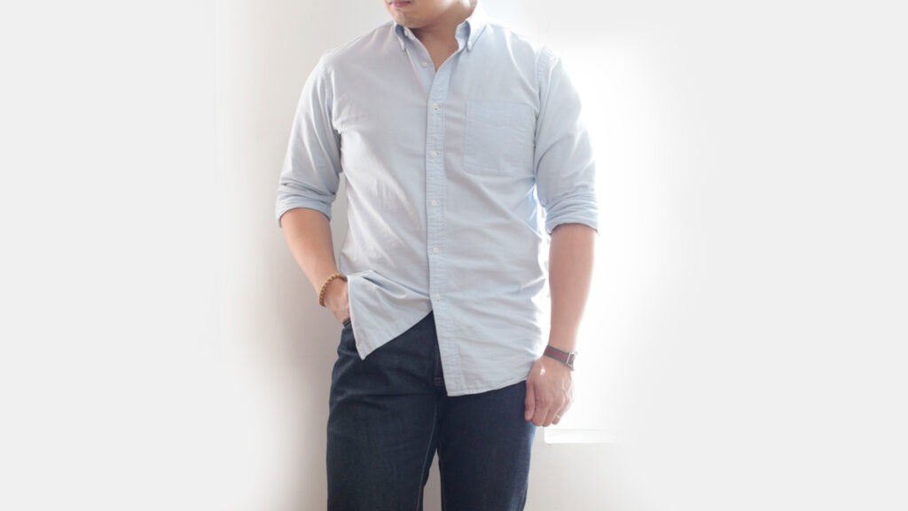cropped photo of man wearing light blue oxford shirt