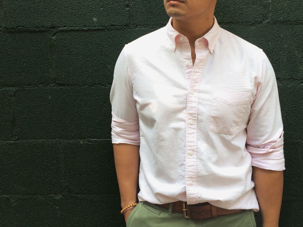 cropped photo of man wearing pink oxford shirt