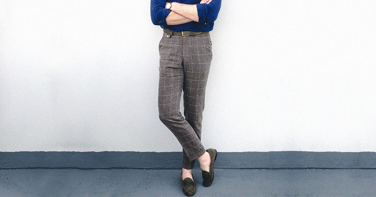 man standing wearing slacks