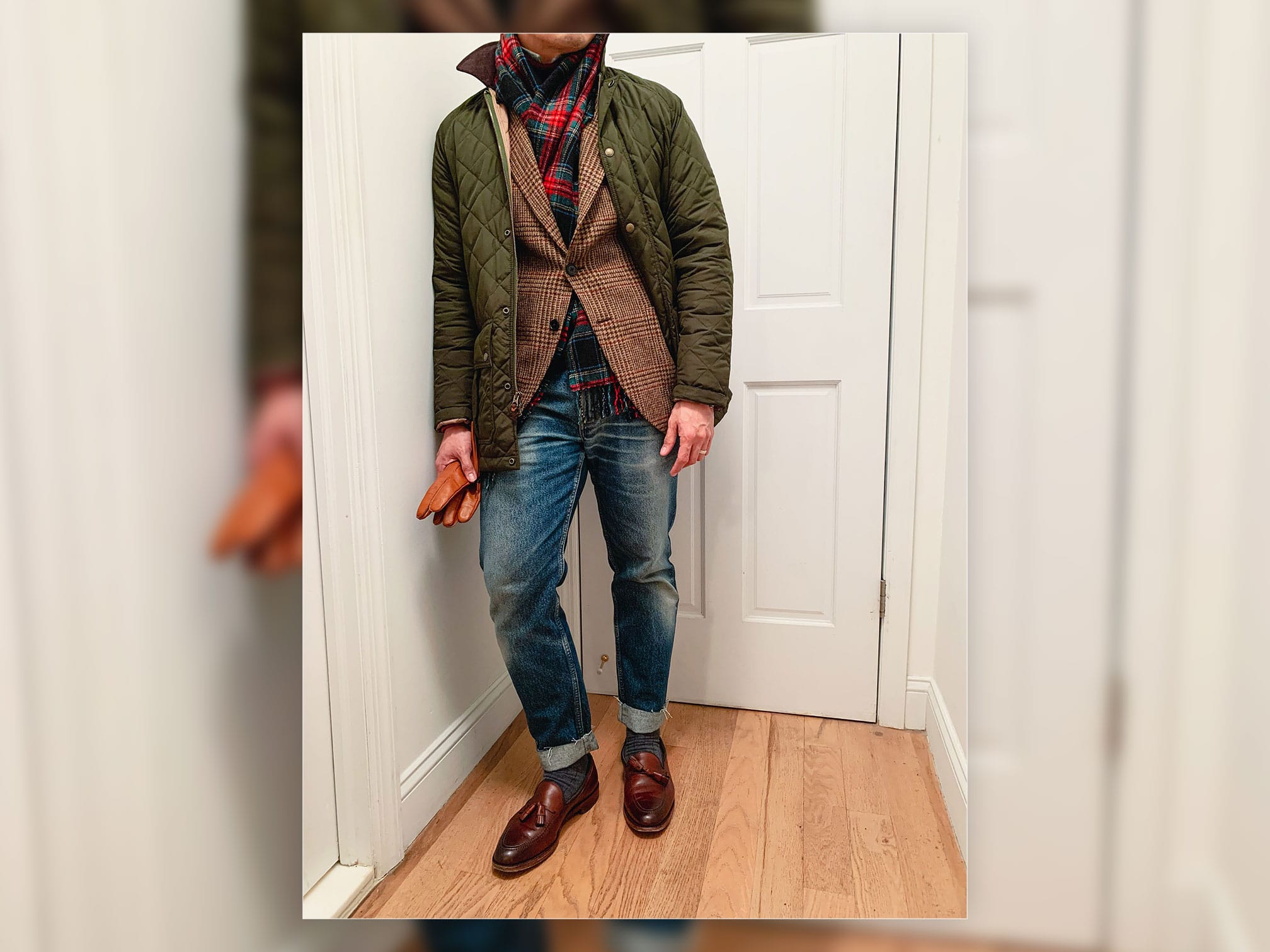 man wearing green quilted jacket and tweed plaid sportcoat with jeans and brown loafers