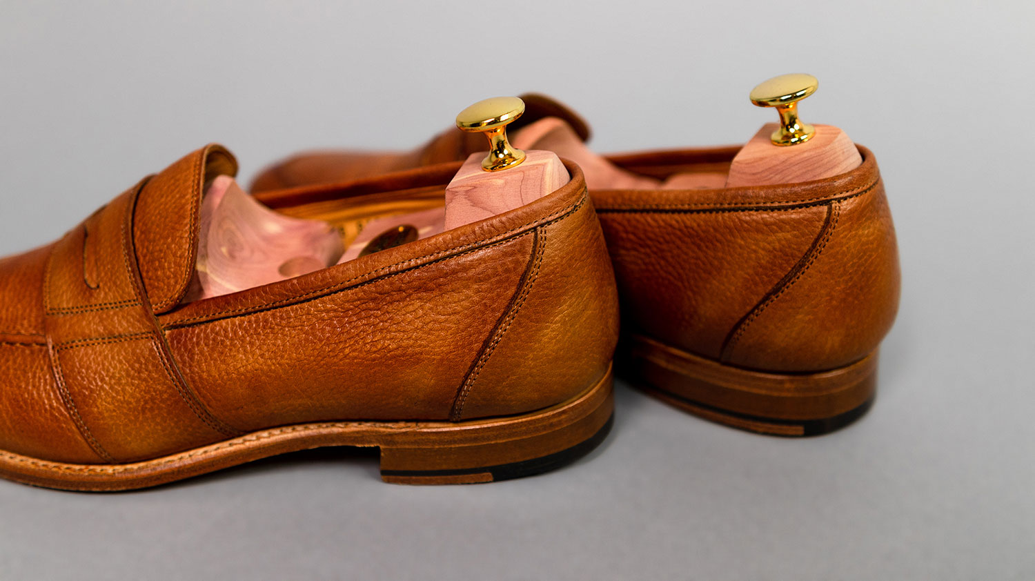 heel close-up of tan leather loafers from Herring on gray background