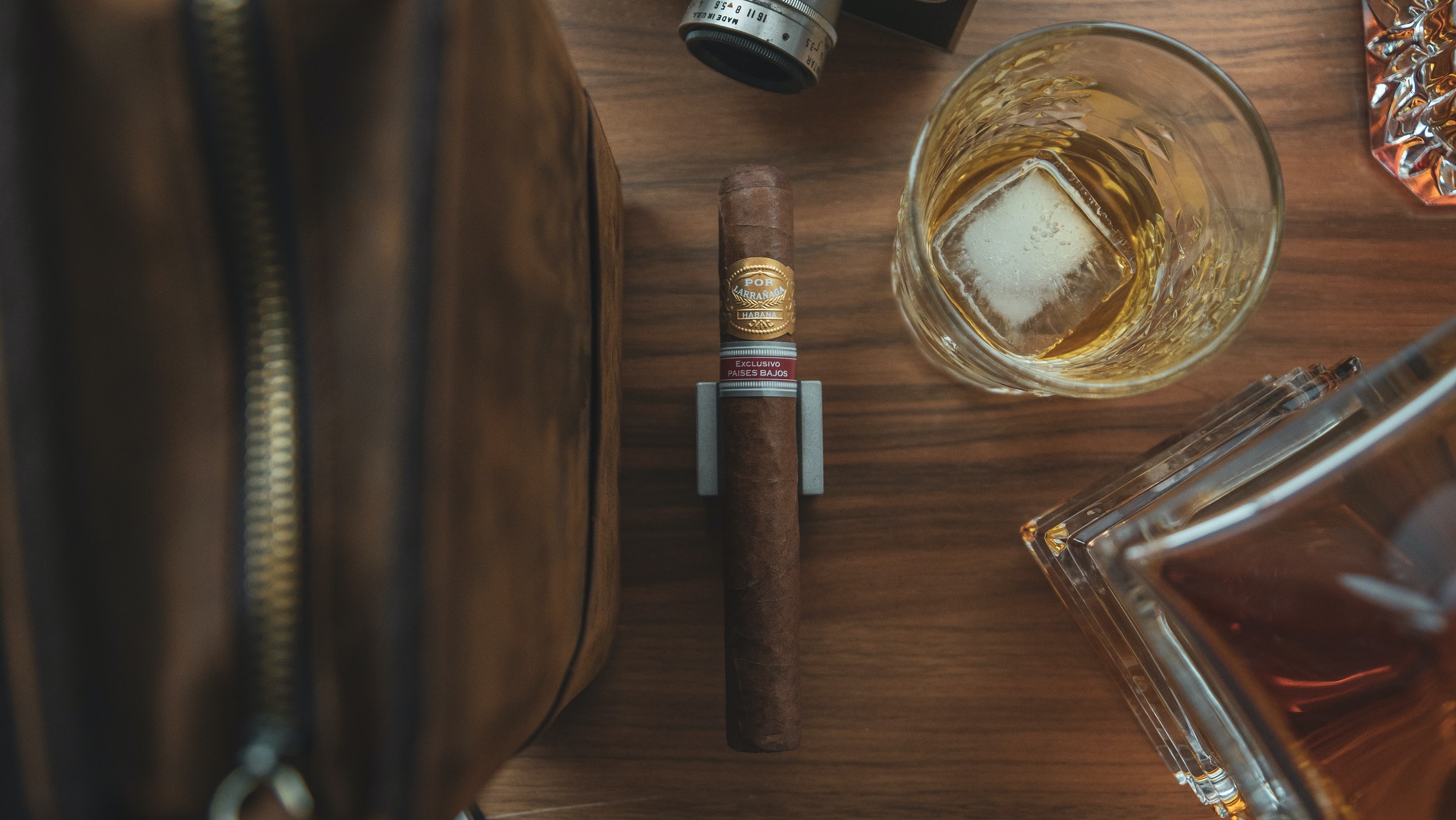 overhead shot of cigar and whiskey glass